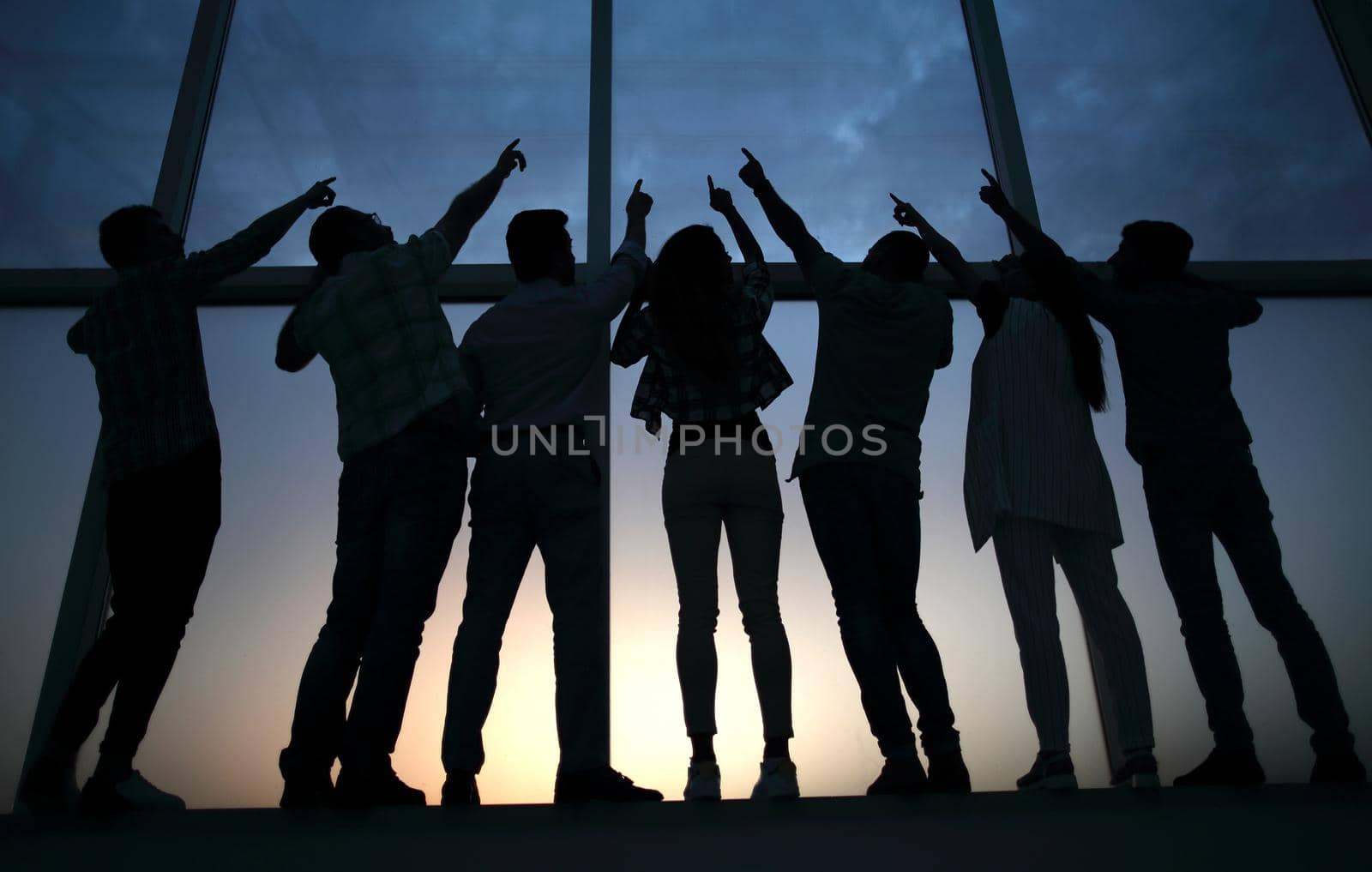 in full growth. business team pointing up.the concept of teamwork