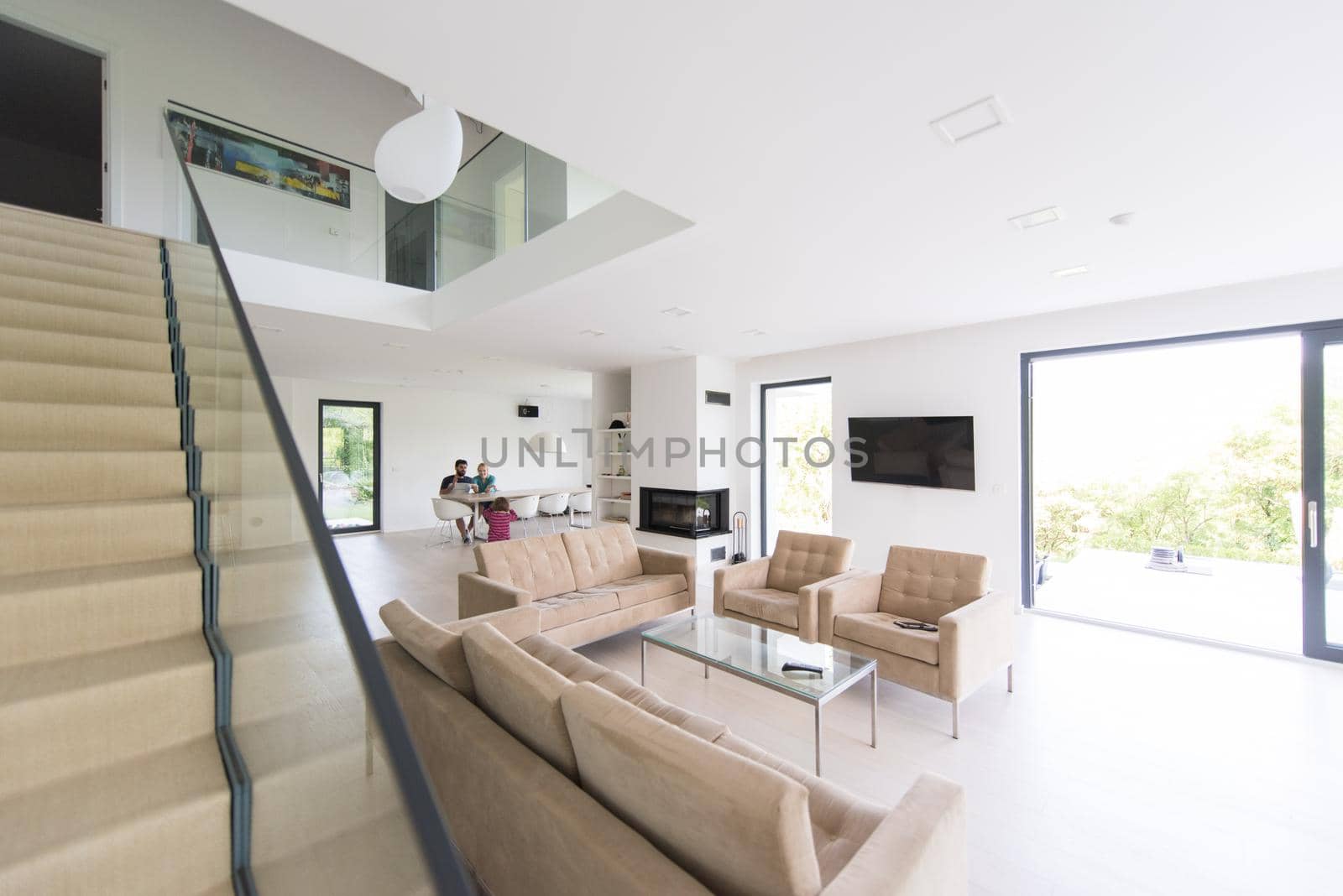 happy young family with little girl enjoys in the modern living room of their luxury home villa