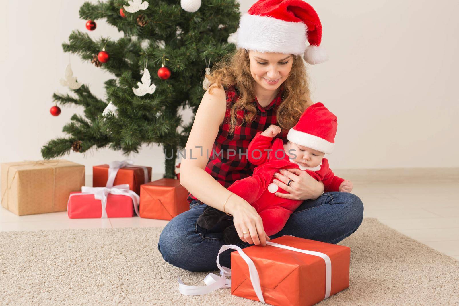 Family, childhood and Christmas concept - Portrait of happy mother and adorable baby in suit of Santa by Satura86