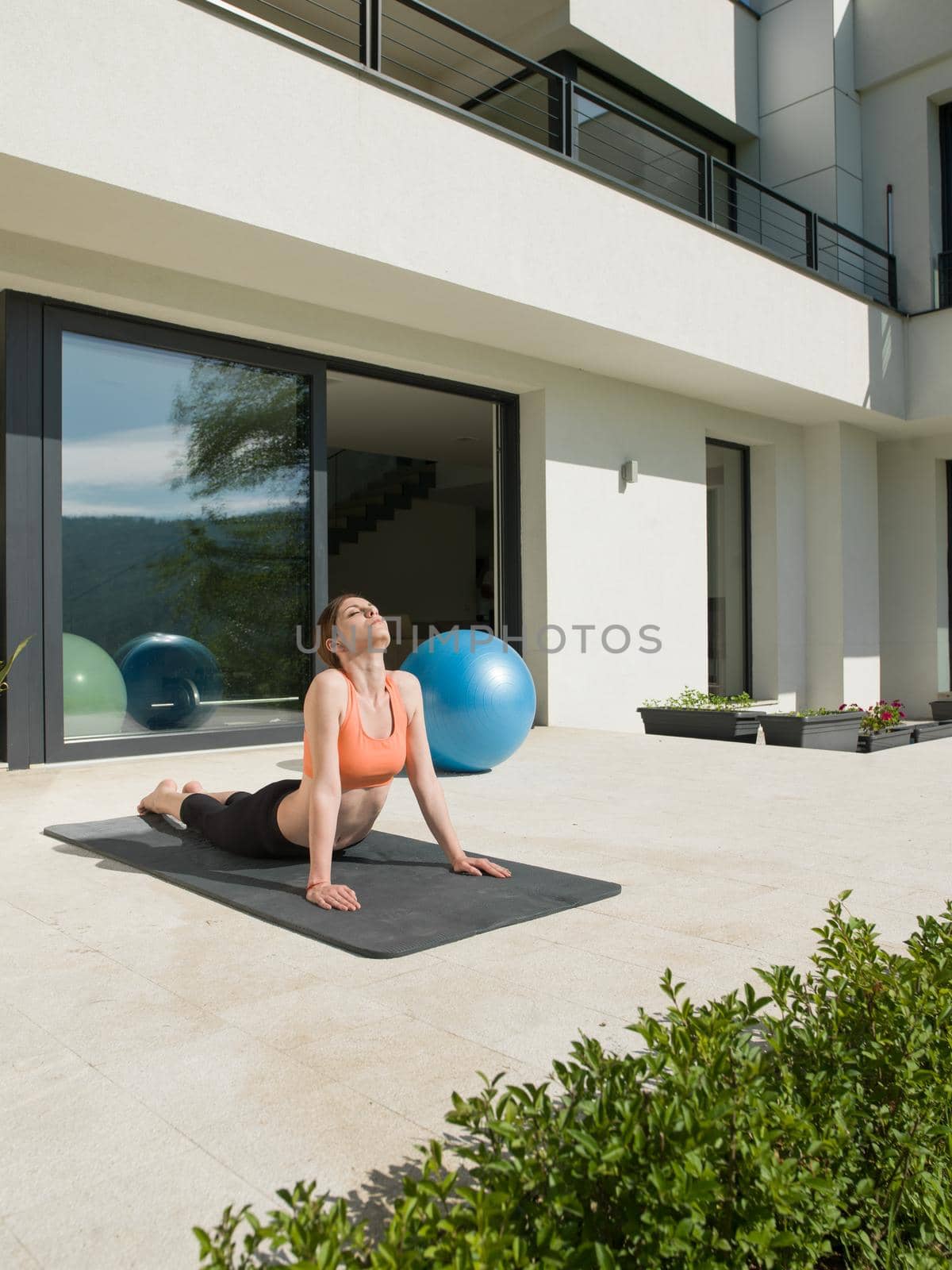 woman doing morning yoga exercises by dotshock