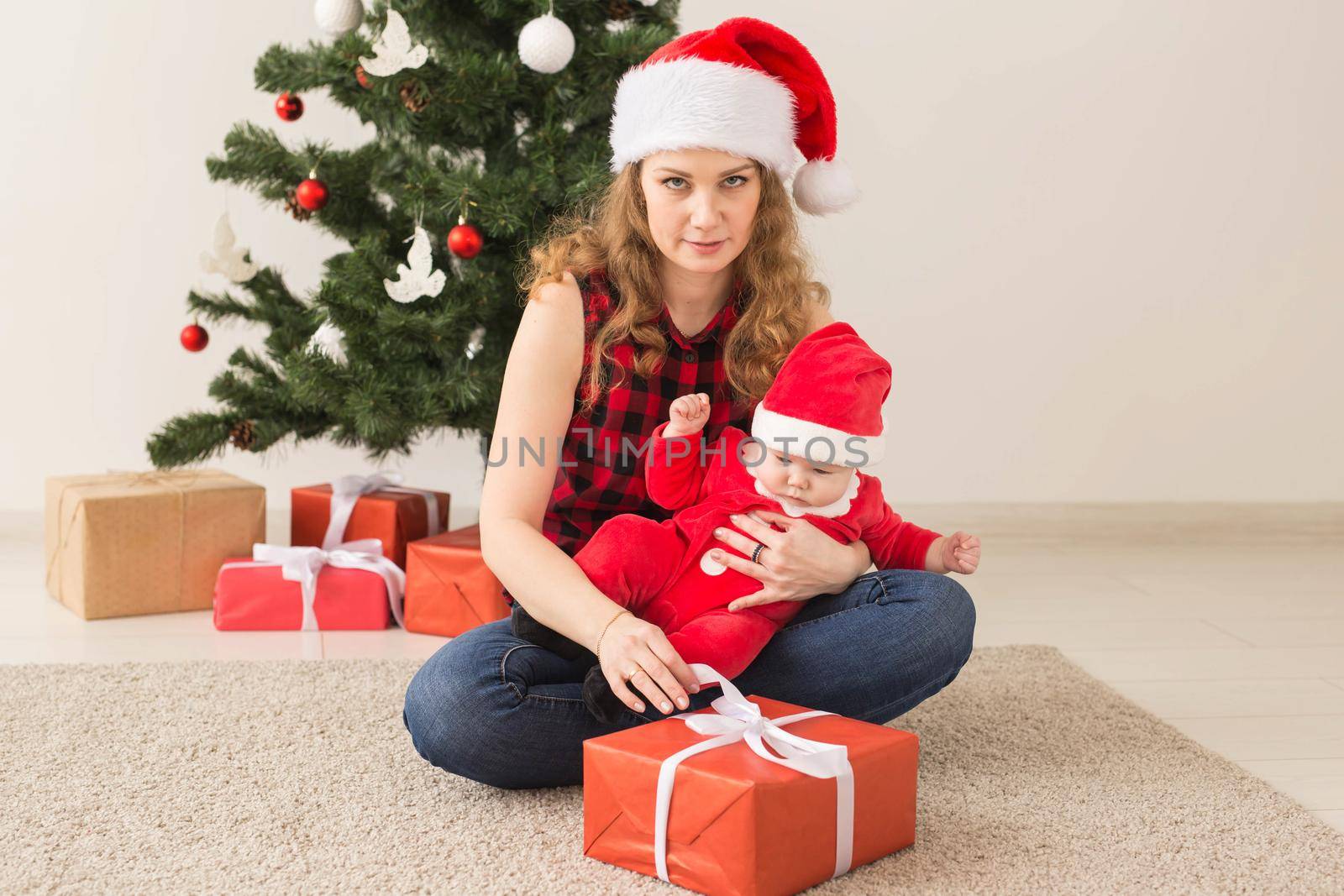 Family, childhood and Christmas concept - Portrait of happy mother and adorable baby in suit of Santa by Satura86