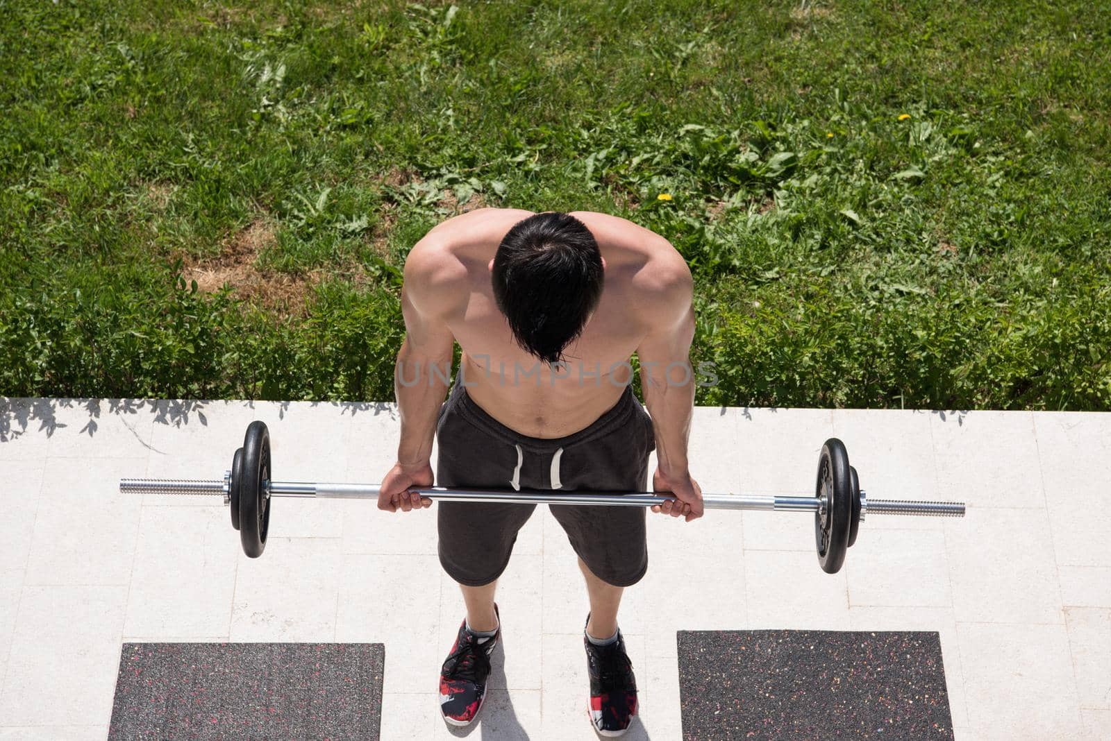 young handsome man doing morning exercises in front of his luxury home villa