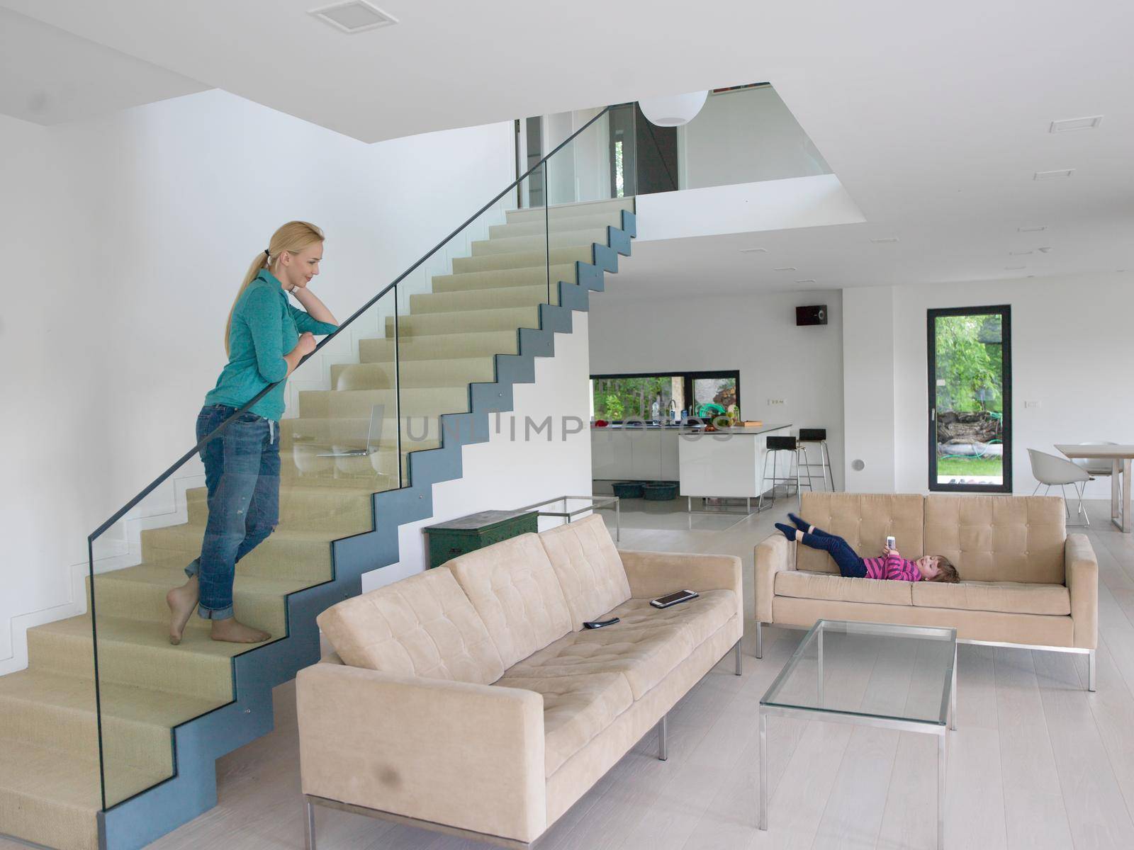 portrait of a young beautiful woman on the stairs in her luxurious home