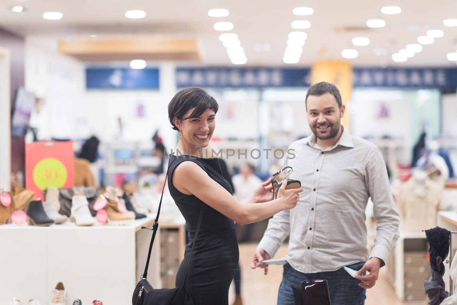 A young attractive couple changes the look with new shoes  At Shoe Store