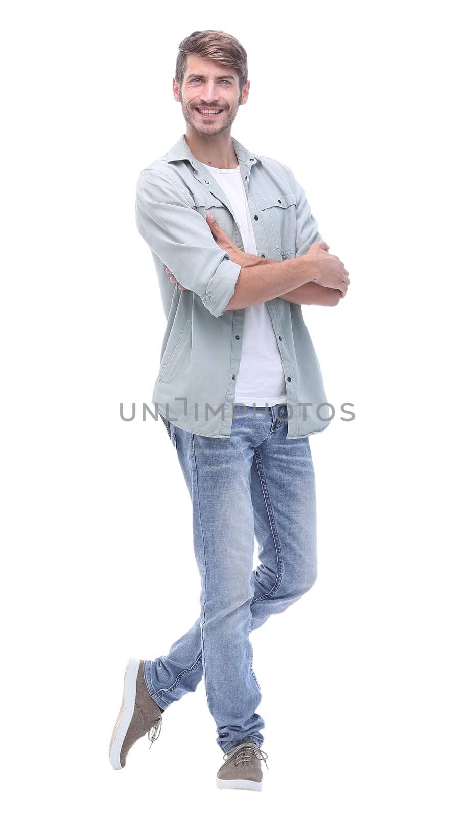 in full growth. smiling young man in jeans.isolated on white background