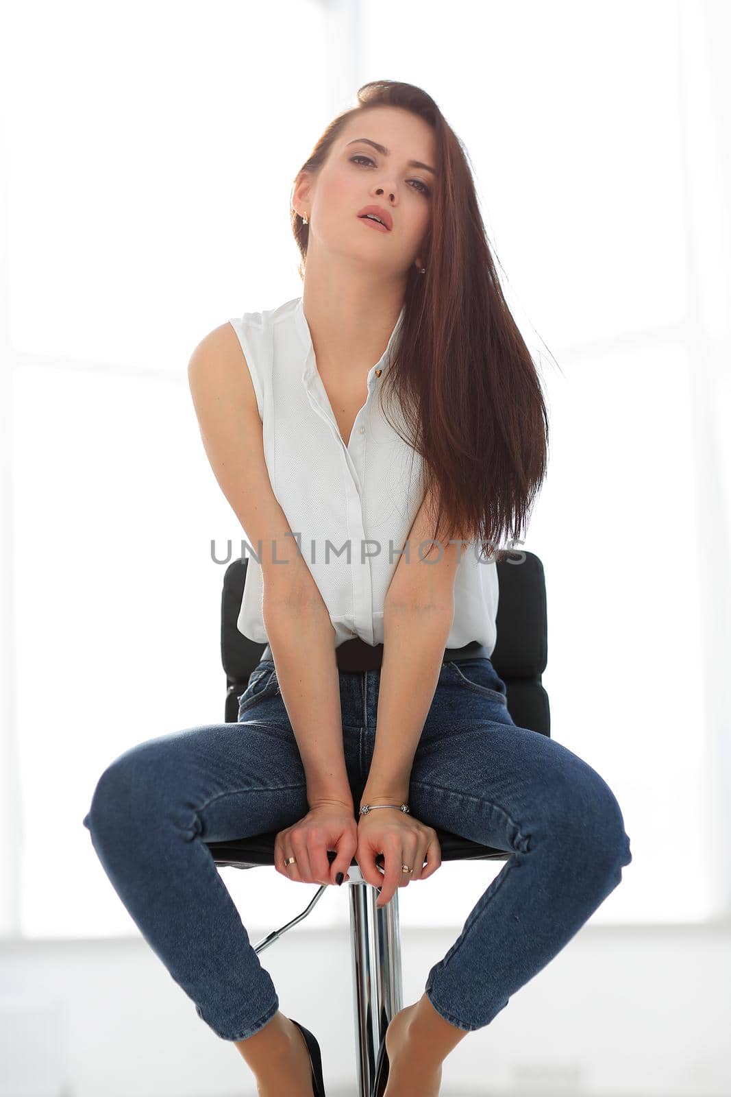 beautiful young woman sitting in a chair.isolated on white background