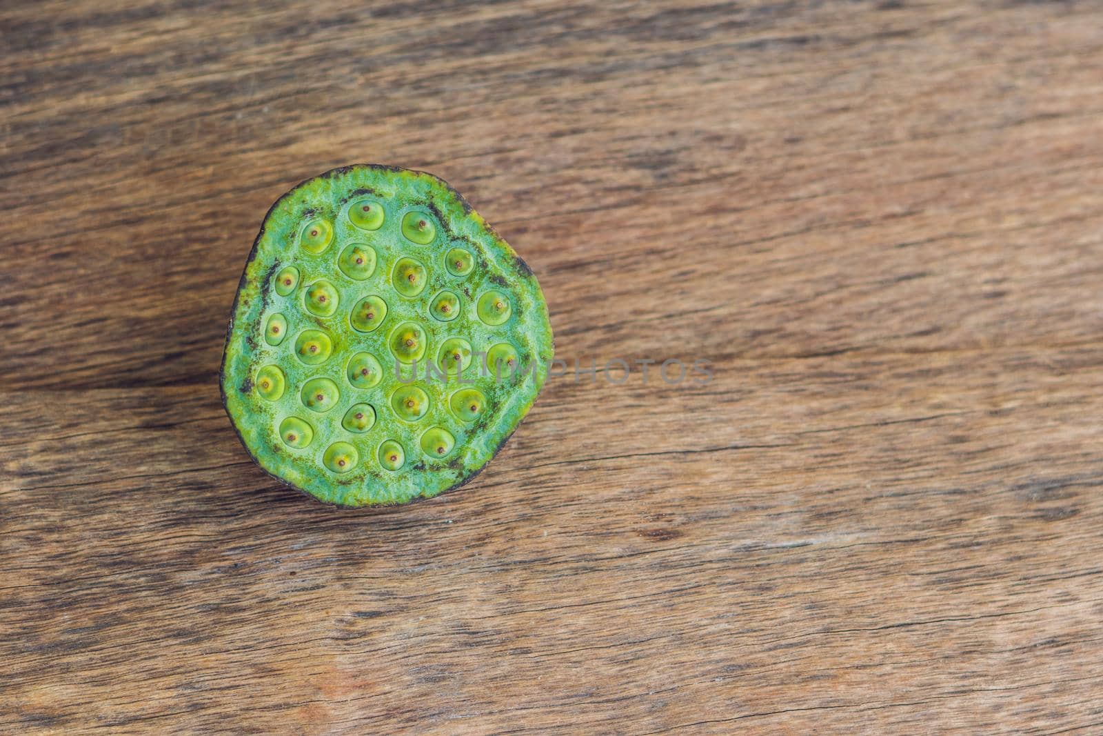 Lotus seeds on an old wooden background.