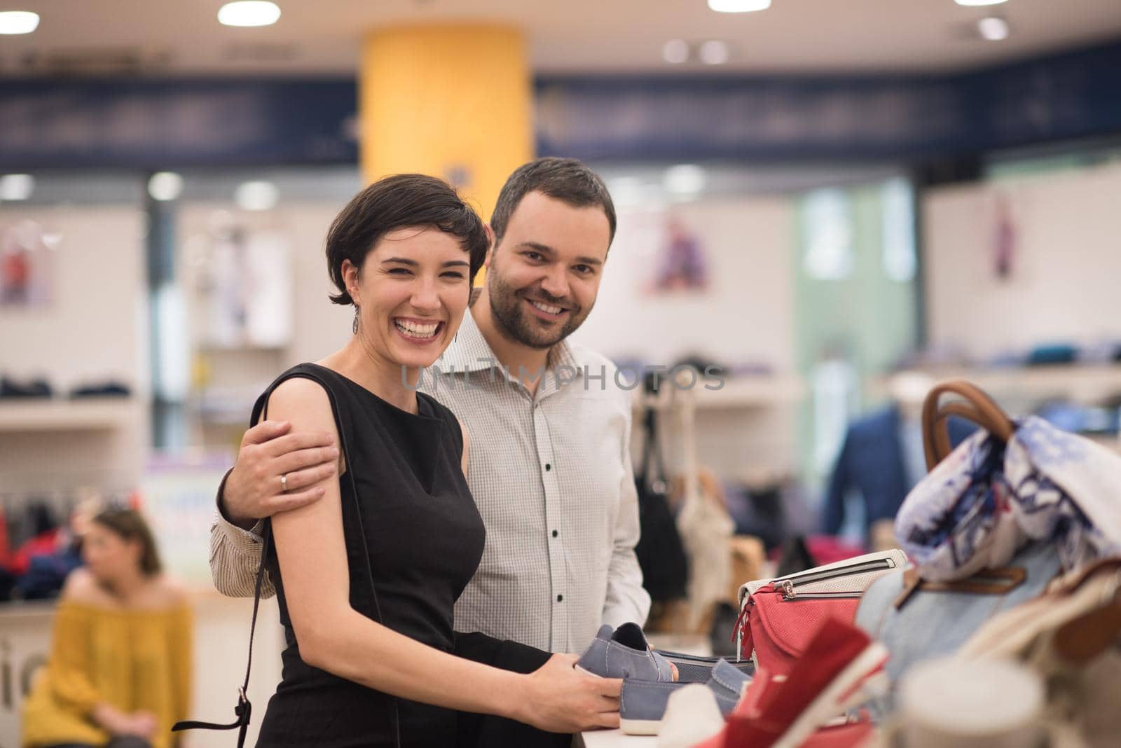 A young attractive couple changes the look with new shoes  At Shoe Store