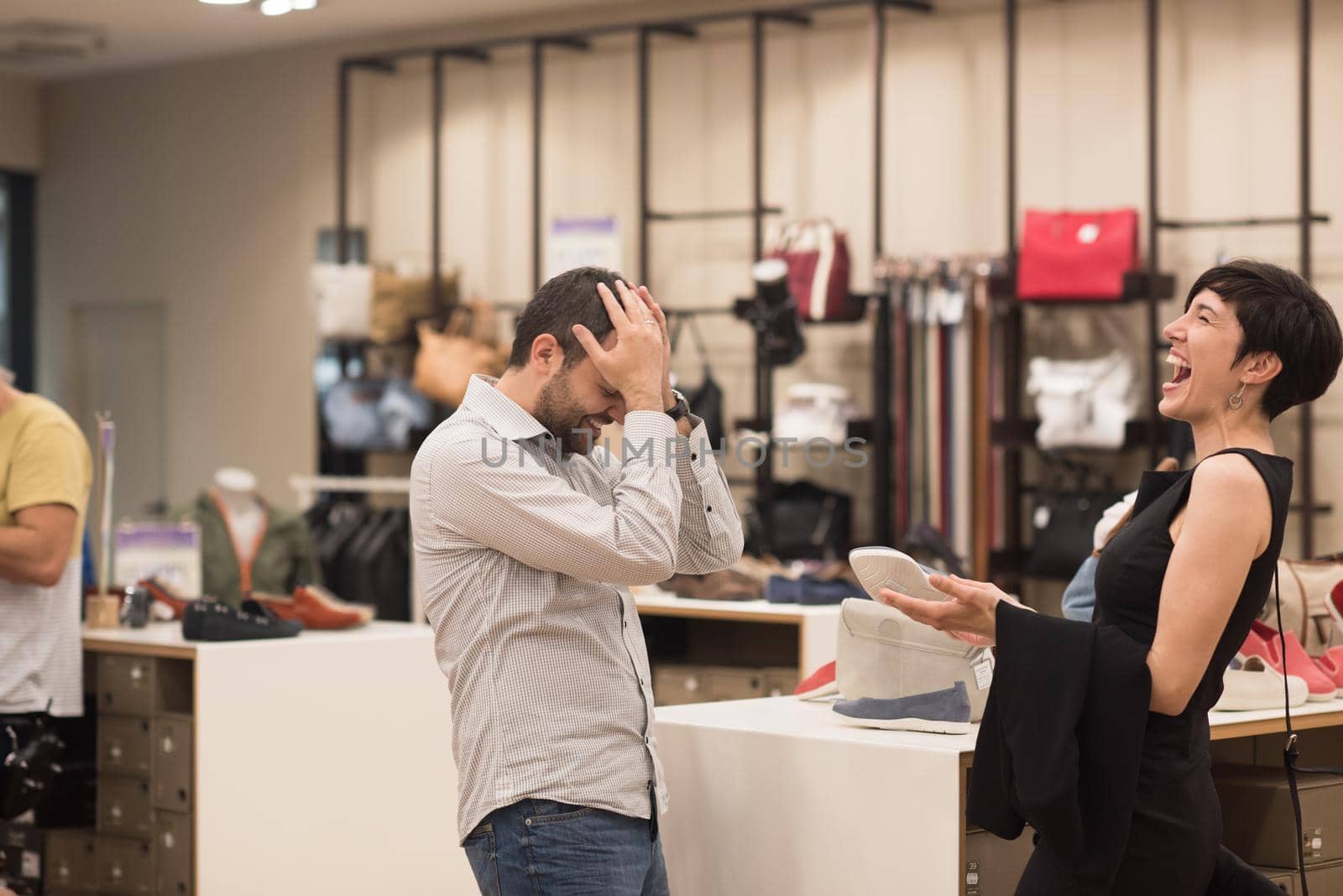 A young attractive couple changes the look with new shoes  At Shoe Store