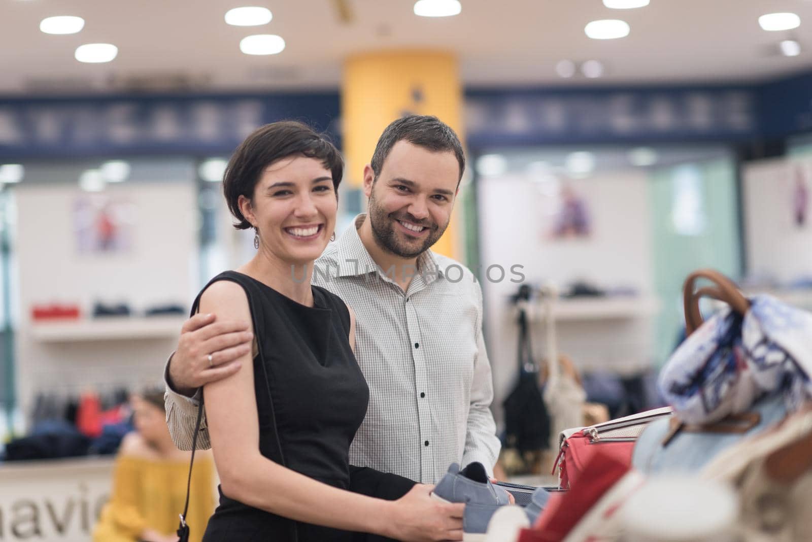 A young attractive couple changes the look with new shoes  At Shoe Store