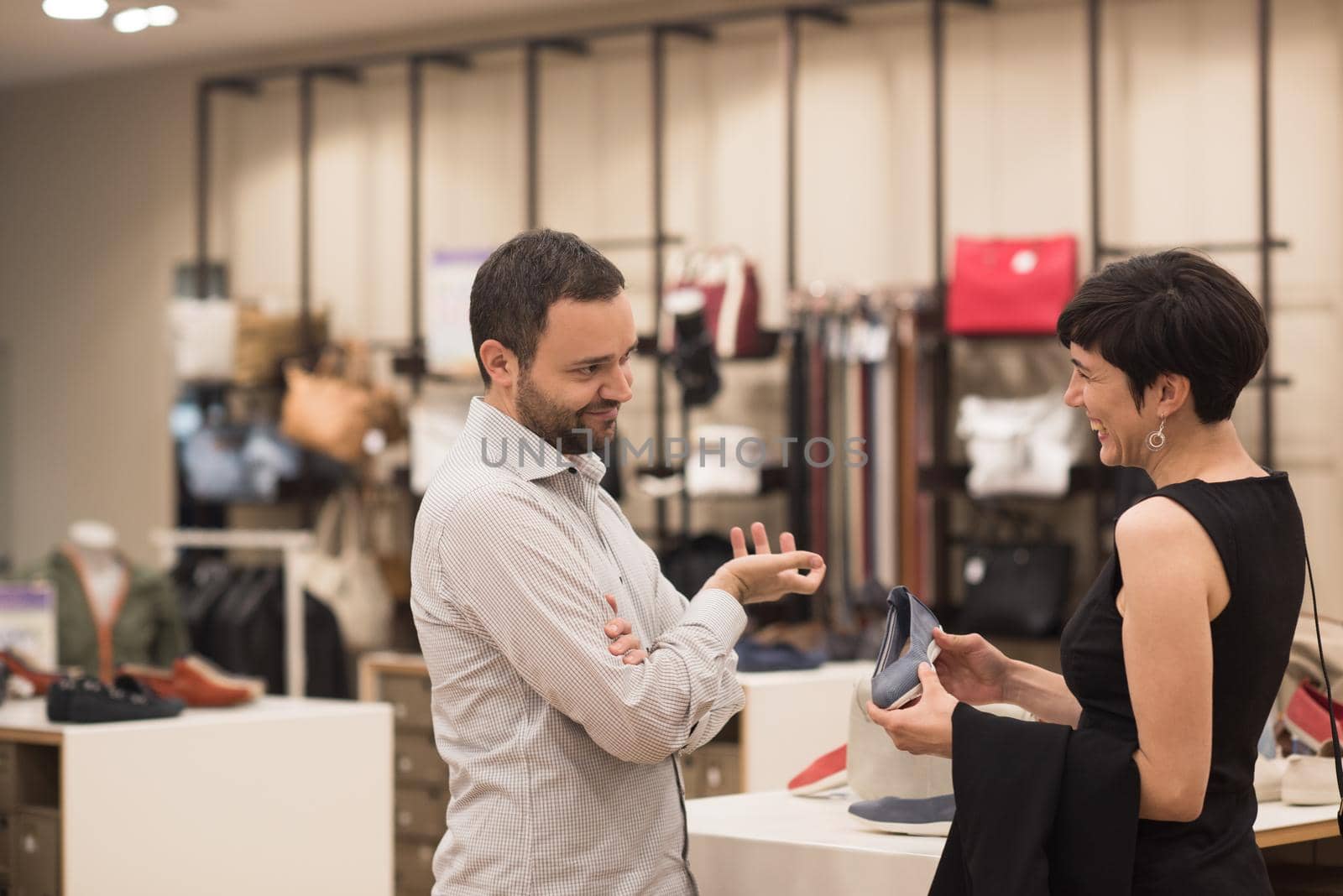 A young attractive couple changes the look with new shoes  At Shoe Store