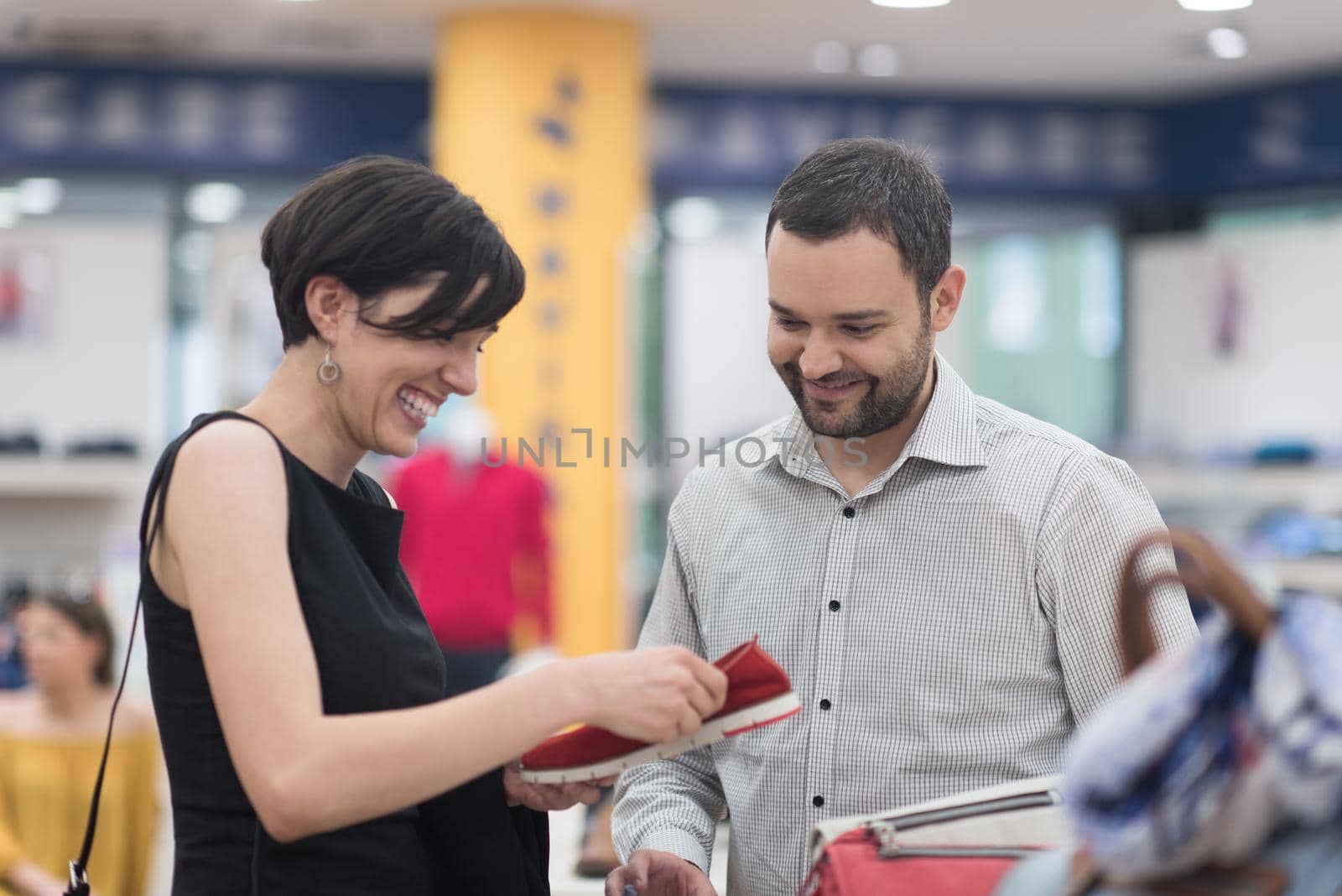 A young attractive couple changes the look with new shoes  At Shoe Store