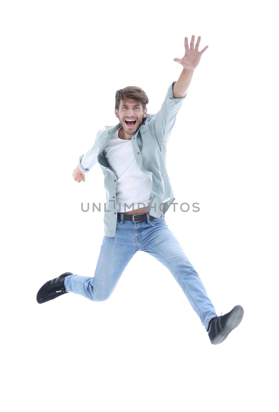 happiness, freedom, movement and people concept - smiling young man jumping in air