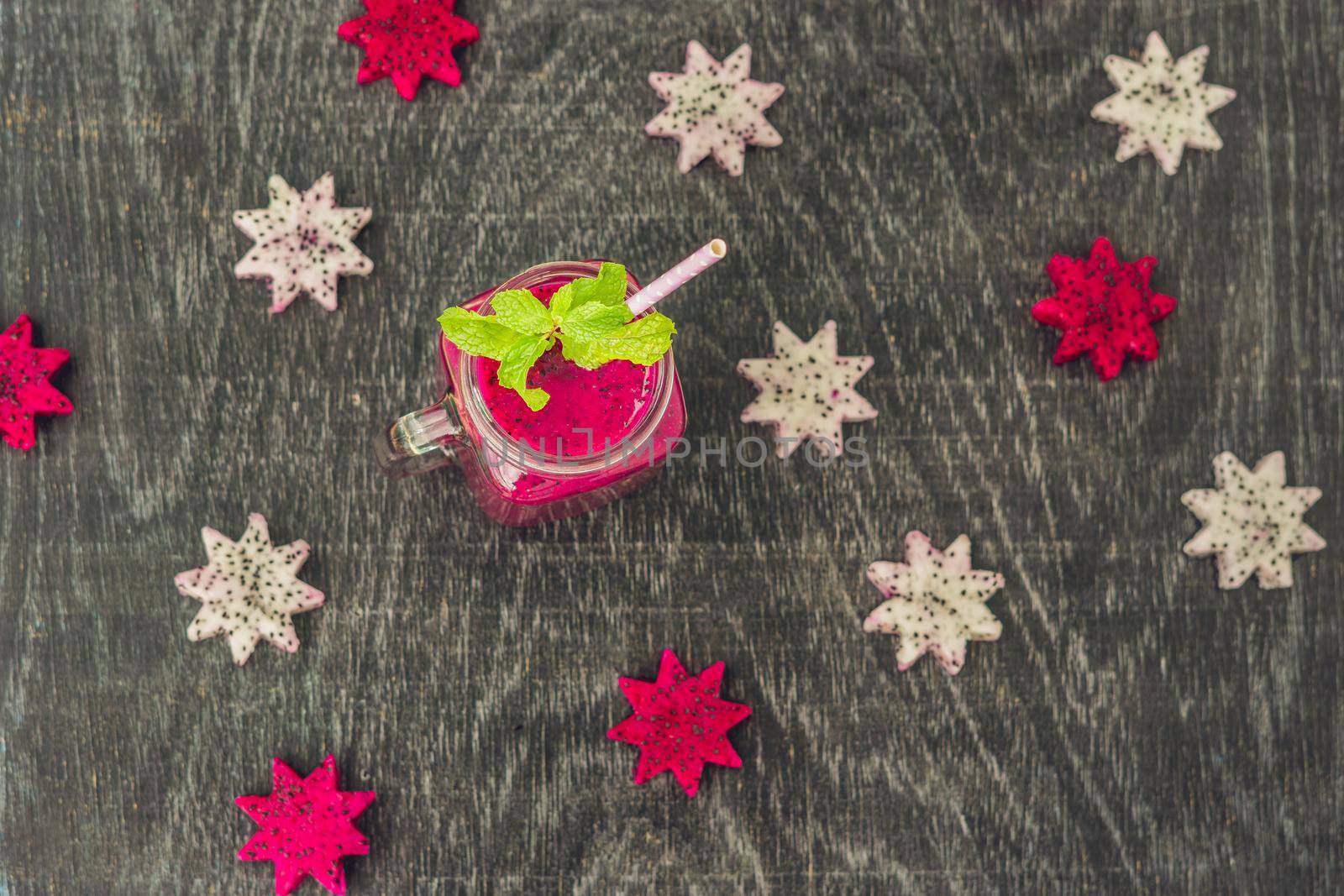 Pieces of sliced dragon fruit in the form of a star and smoothies from a dragon fruit on an old withered background.