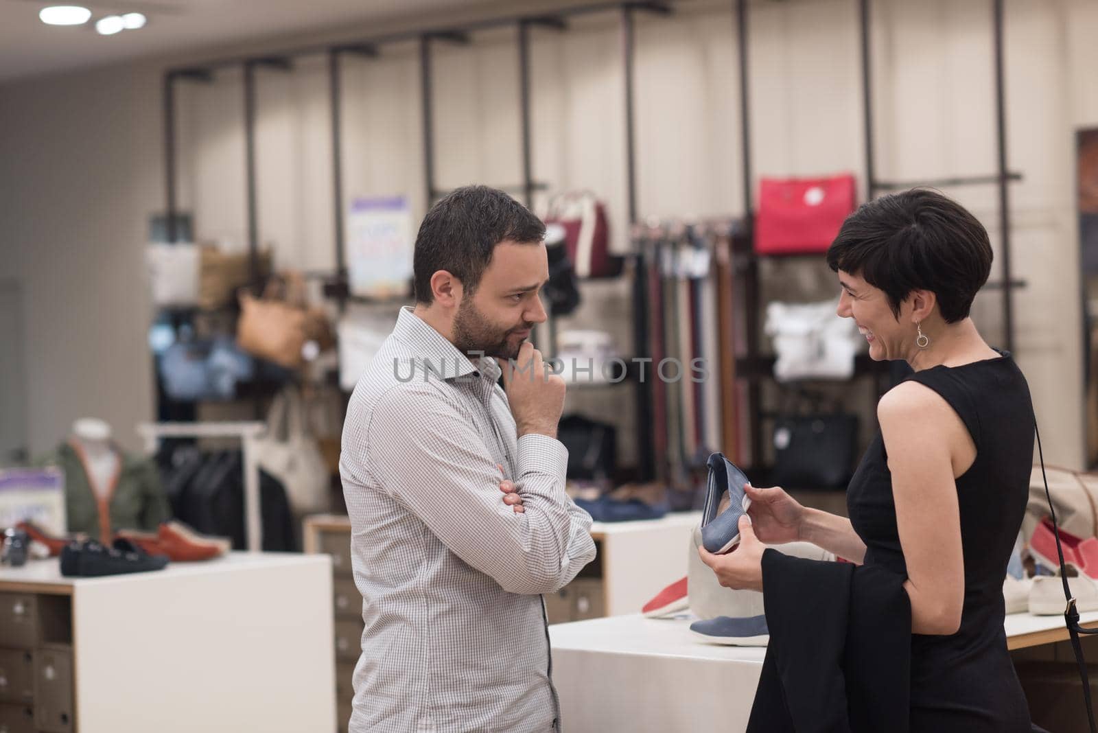 A young attractive couple changes the look with new shoes  At Shoe Store