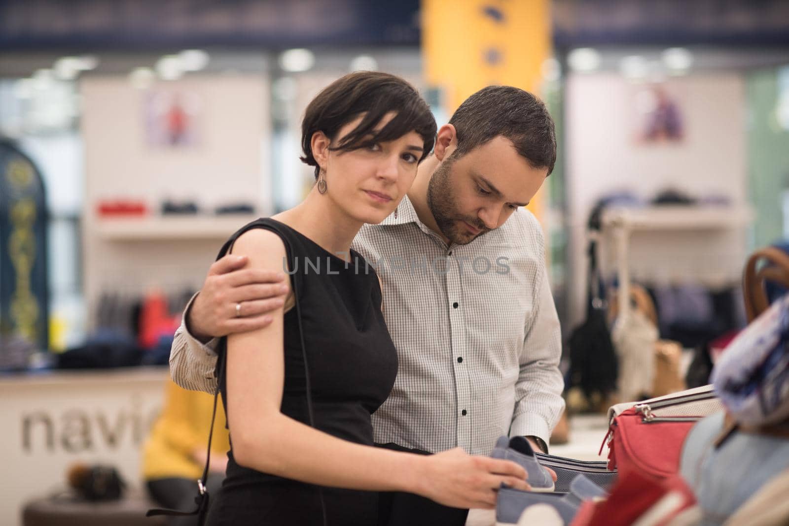 A young attractive couple changes the look with new shoes  At Shoe Store