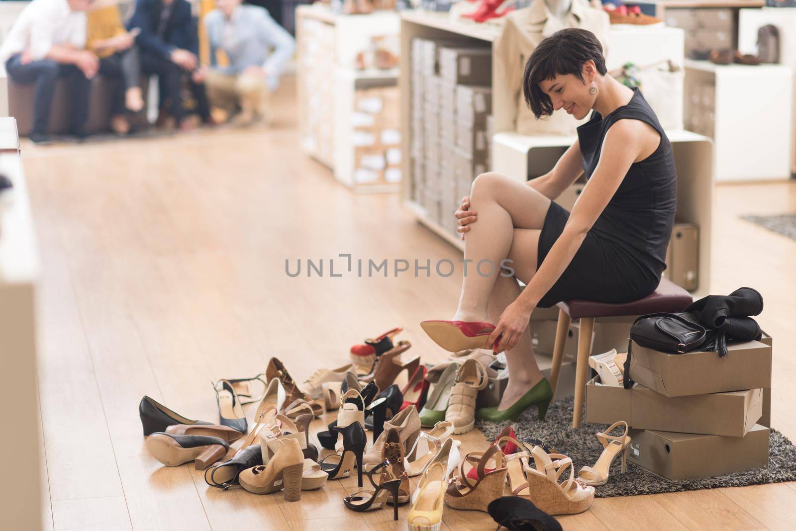 Woman Chooses  Shoes At Fashionable Shop