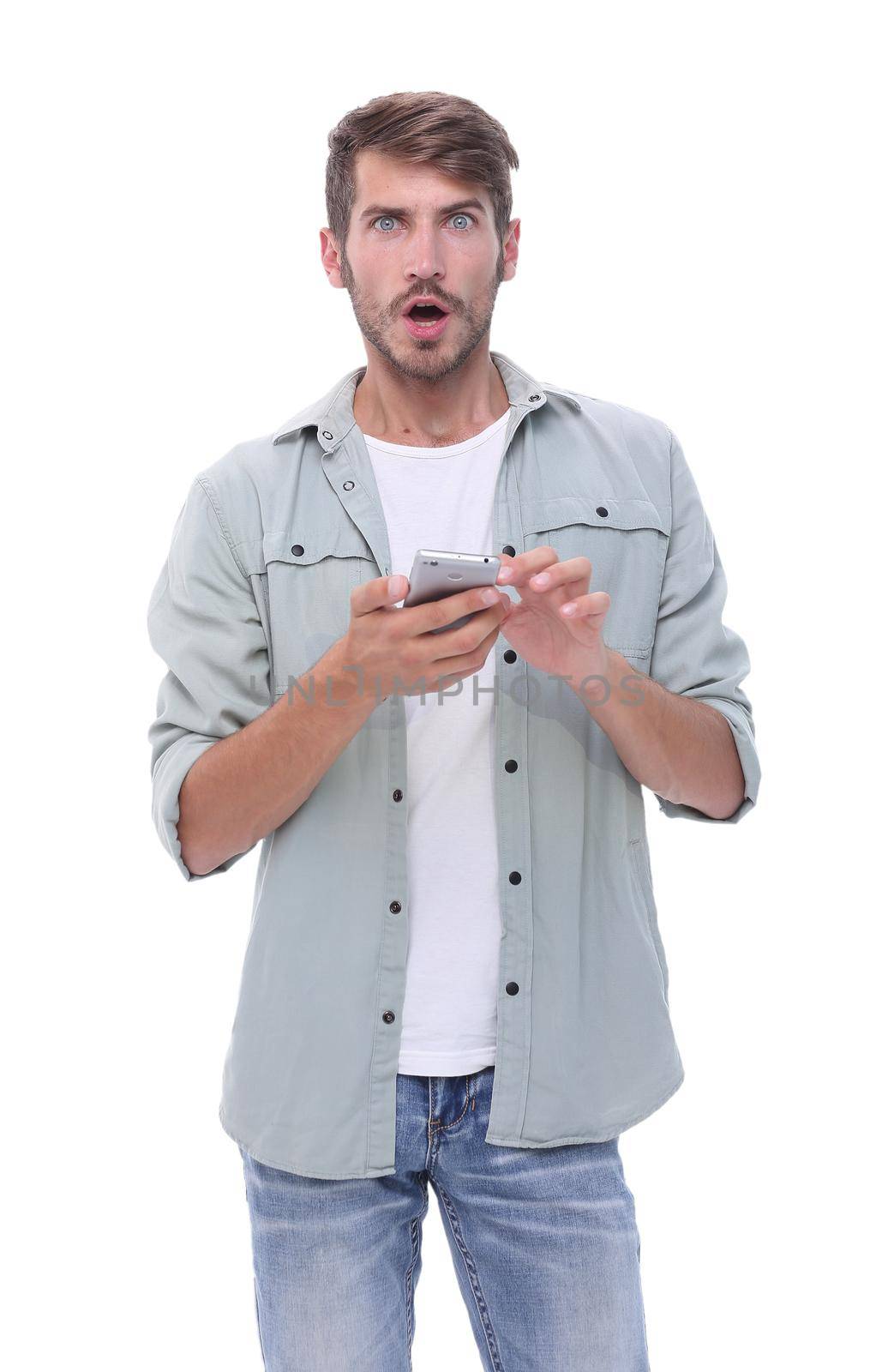 in full growth.surprised young man with smartphone .isolated on white background