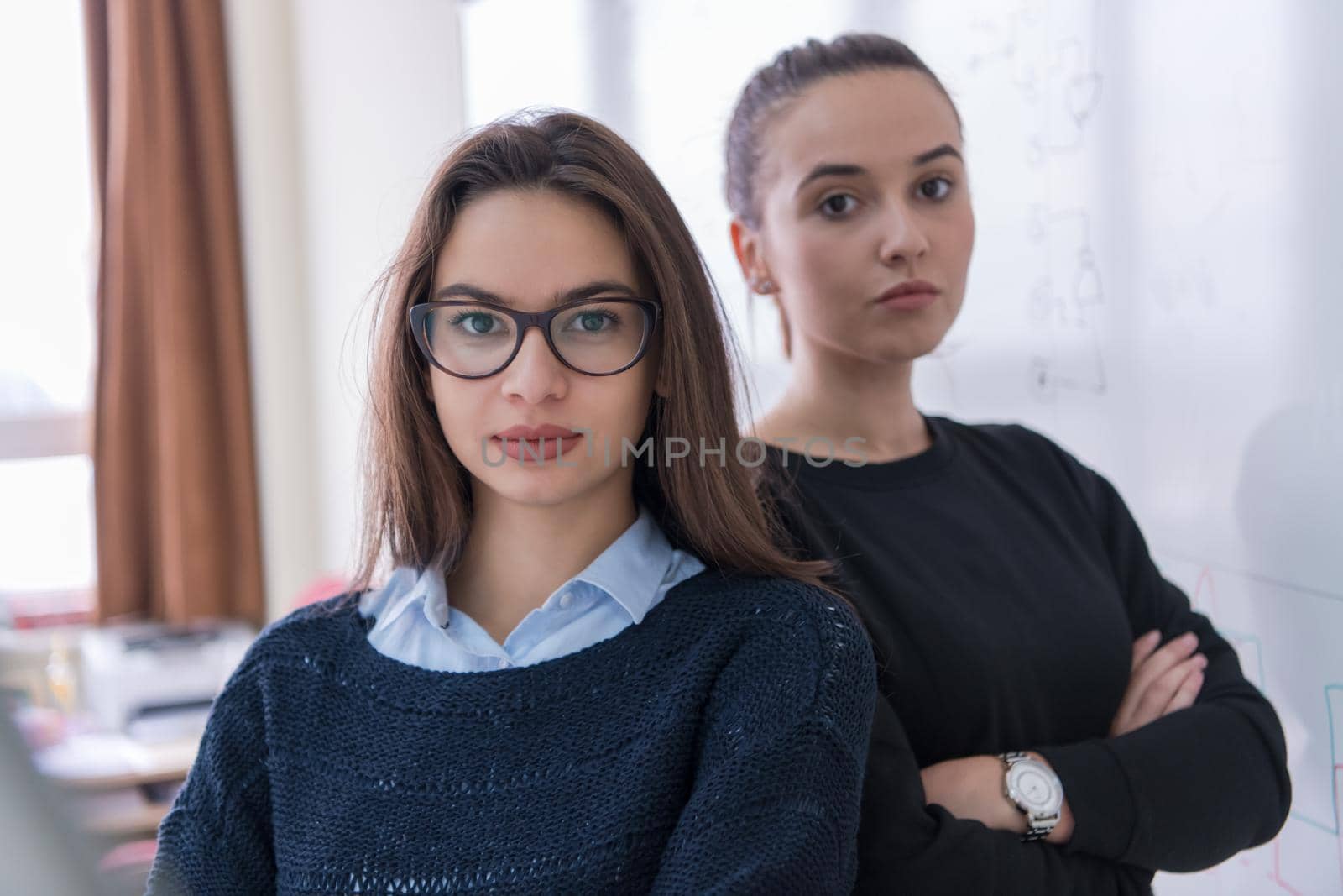 portrait of two young female students by dotshock