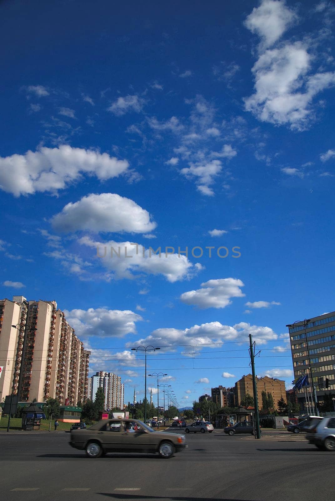 traffic in the city and blue sky with dramatic clouds by dotshock