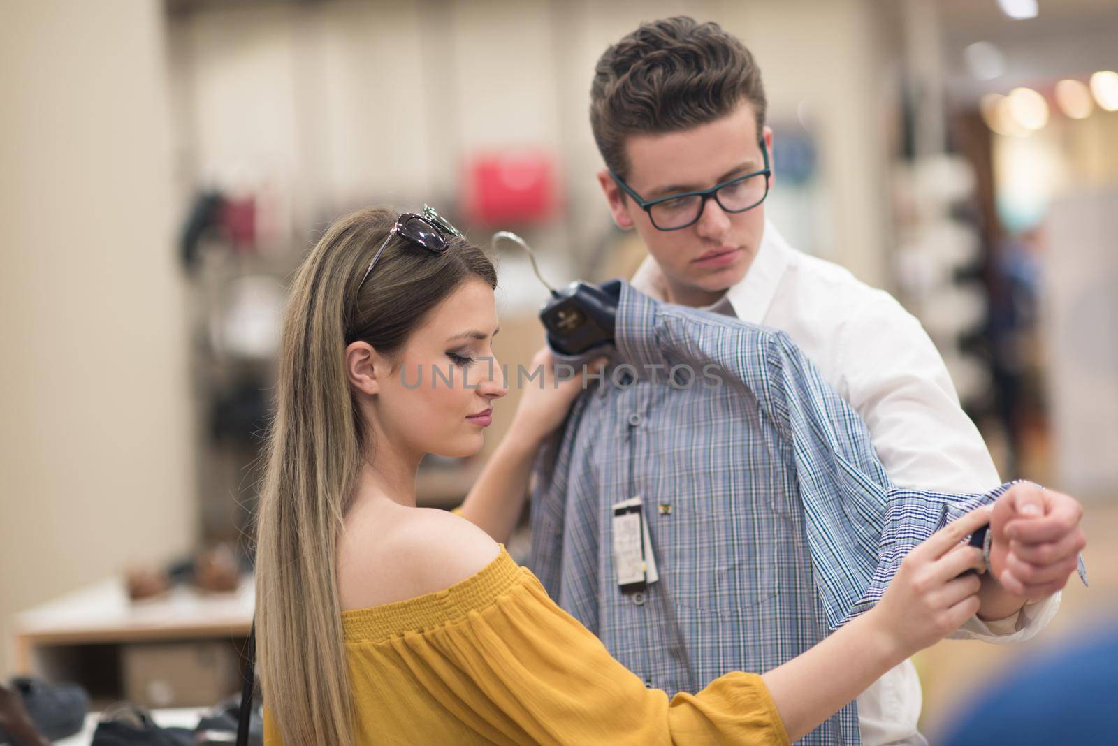 Attractive Couple Shopping In A Man's Clothing Store