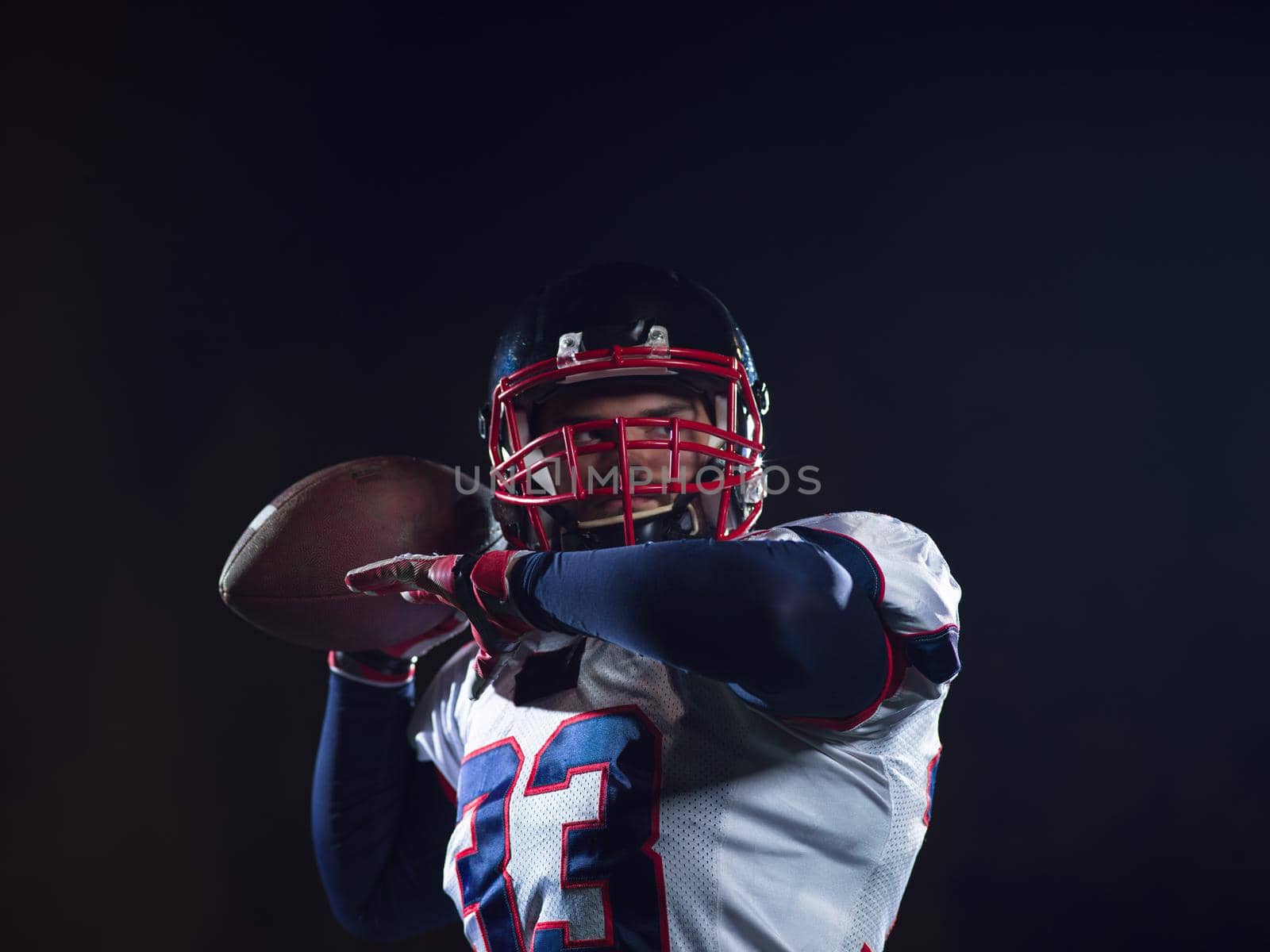 american football player throwing rugby ball by dotshock