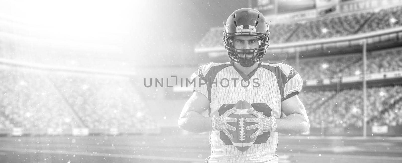 American Football Player isolated on big modern stadium field with lights and flares