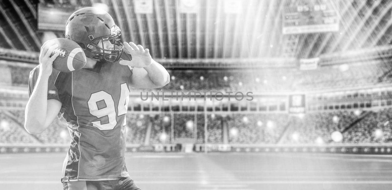 American football Player running with the ball isolated on big modern stadium field with lights and flares