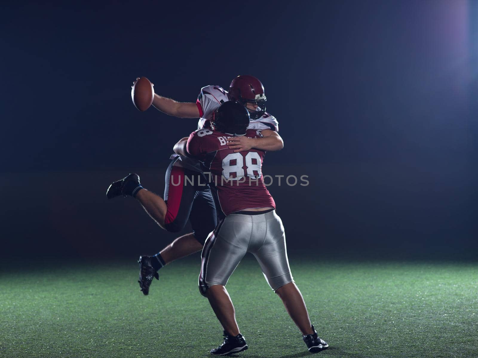 American football players in action at night game time on the field