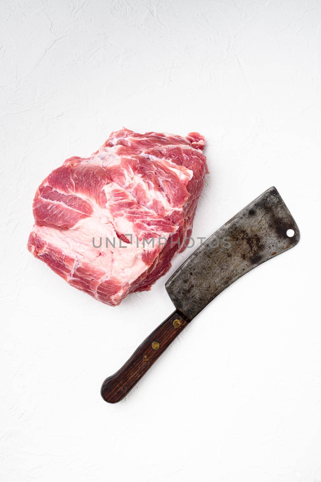 Pork shoulder fresh raw meat set , with old butcher cleaver knife, on white stone table background, top view flat lay, with copy space for text