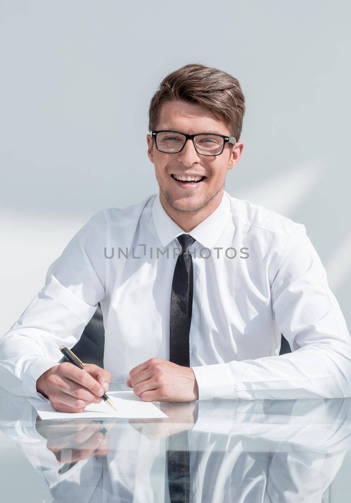 close up.smiling businessman signing contract.business concept