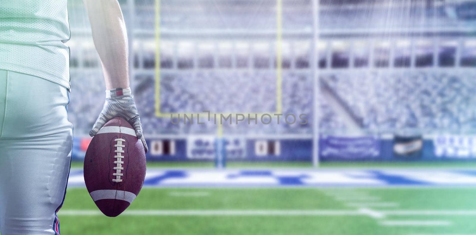 Closeup Portrait of a strong muscular American Football Player on big modern stadium field with lights and flares