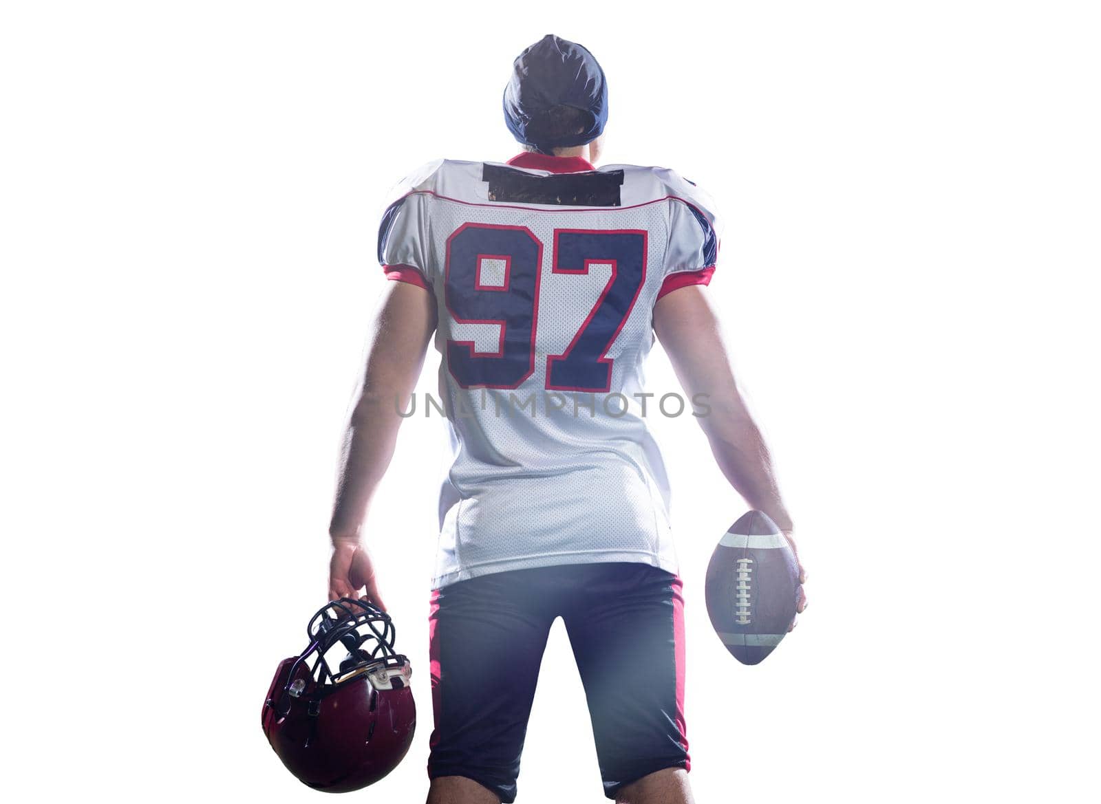 rear view of young confident American football player isolated on white background