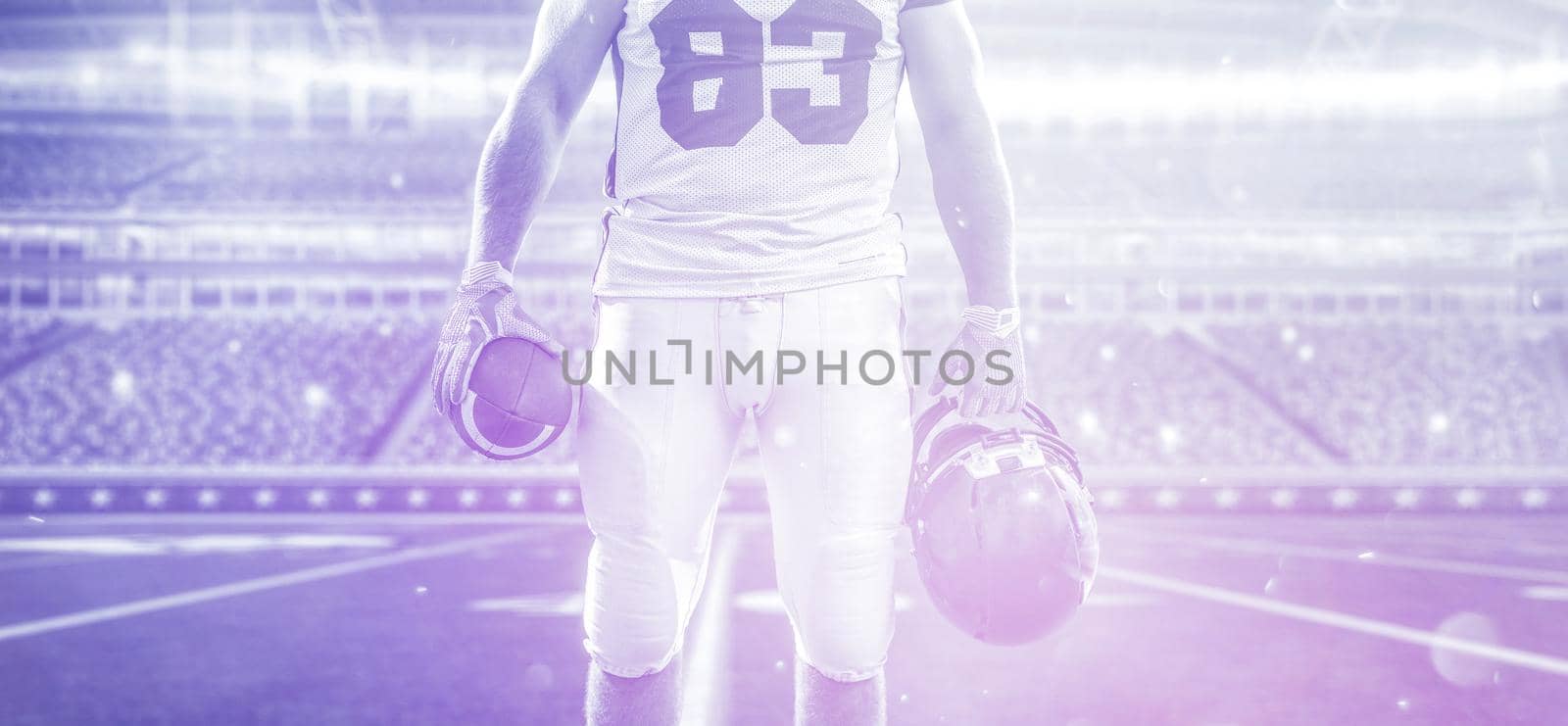 Closeup Portrait of a strong muscular American Football Player on big modern stadium field with lights and flares