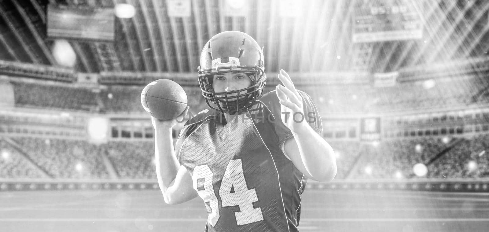 one quarterback american football player throwing ball on big modern stadium with lights and flares