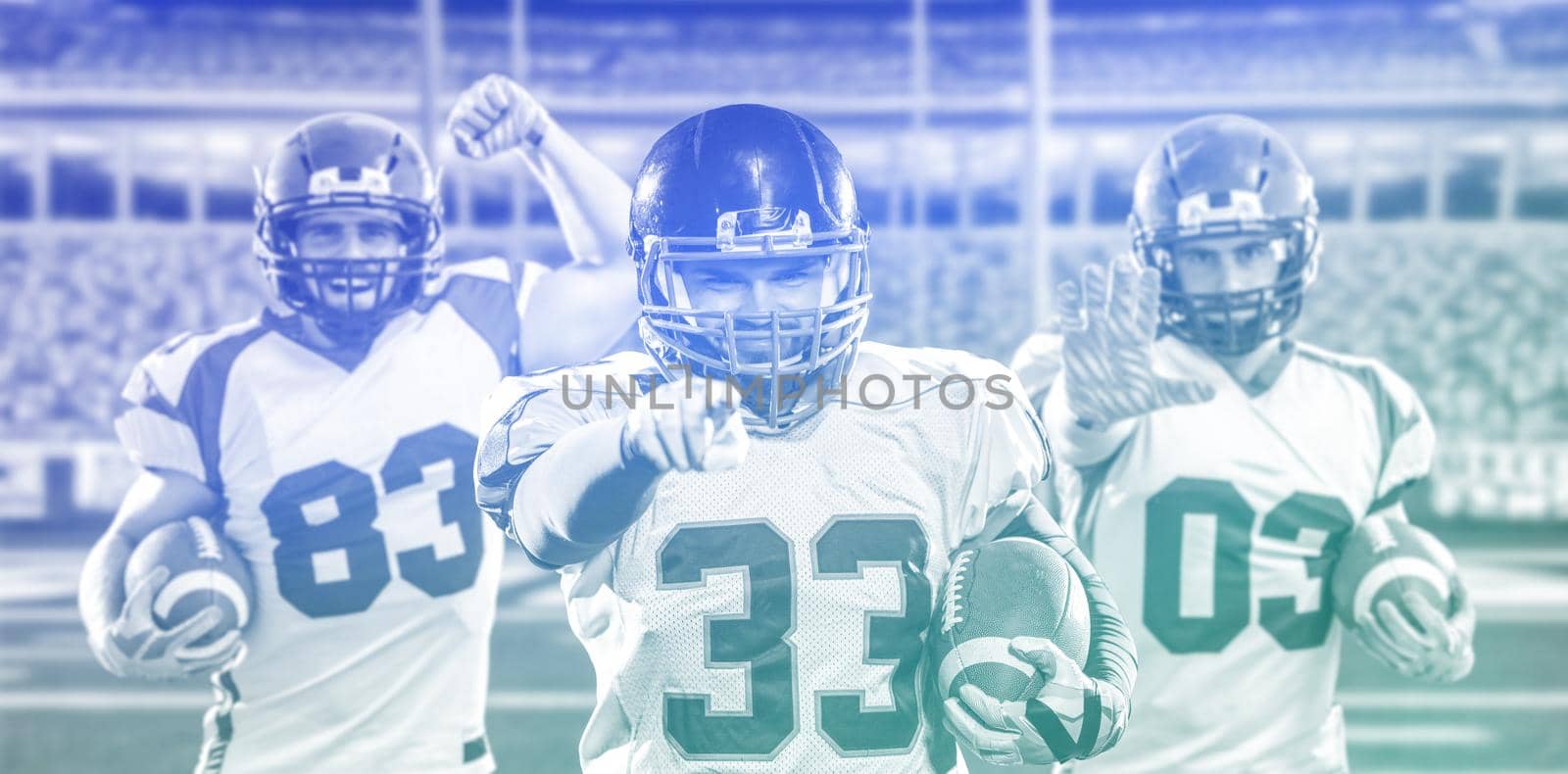 Portrait of American football player pointing against gray background