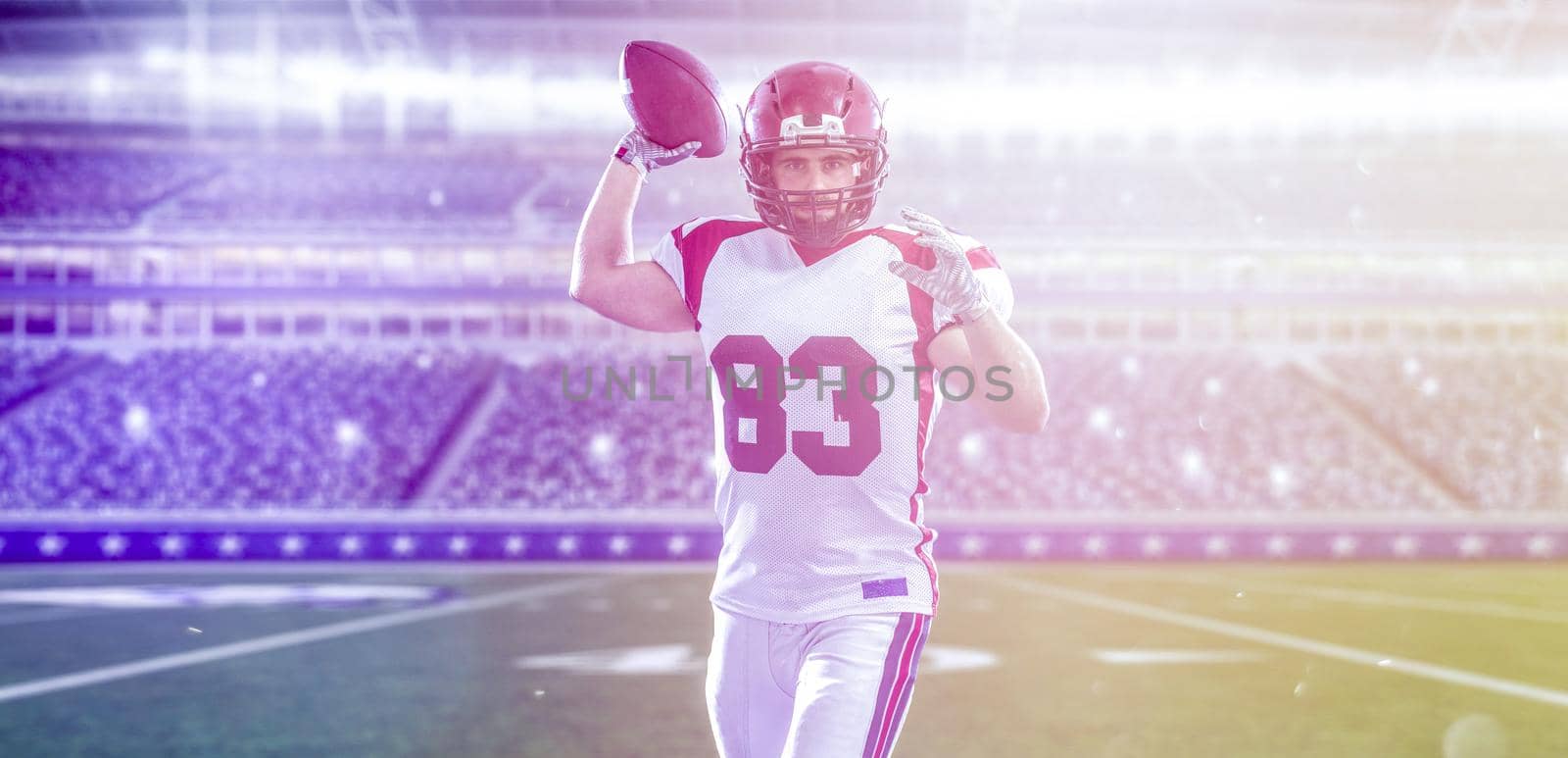 one quarterback american football player throwing ball on big modern stadium field with lights and flares