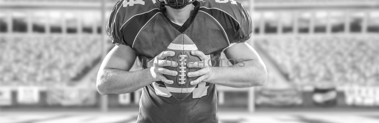 Closeup Portrait of a strong muscular American Football Player on big modern stadium field with lights and flares