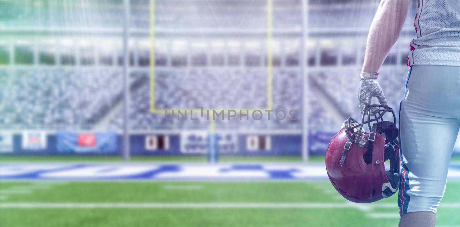 Closeup Portrait of a strong muscular American Football Player on big modern stadium field with lights and flares