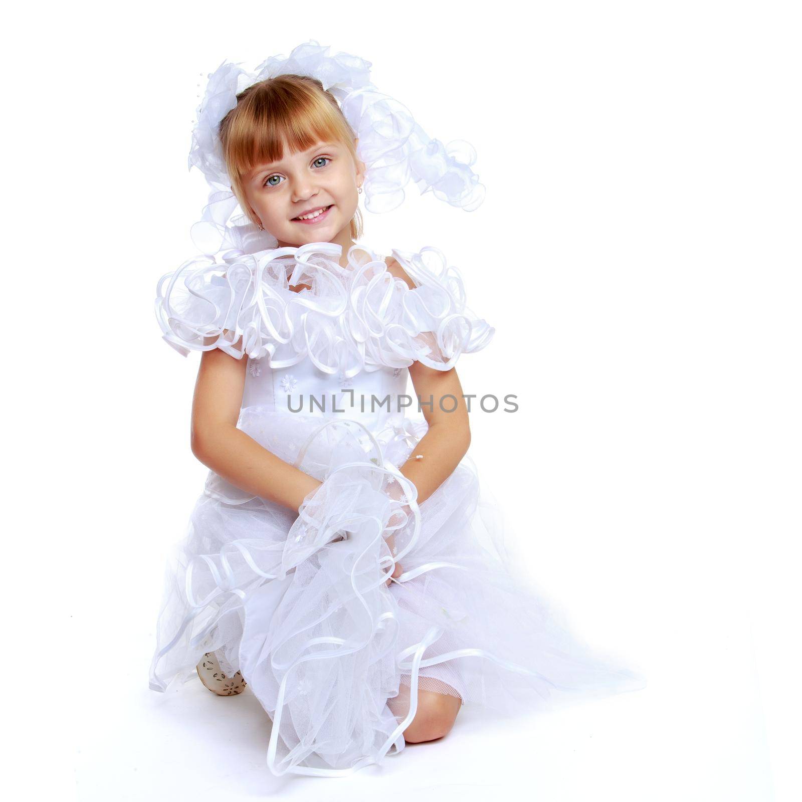 Charming little princess in a long dress. The concept of a happy childhood, beauty and fashion. Isolated on white background.