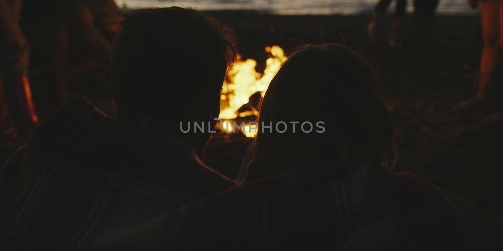 Couple enjoying with friends at night on the beach by dotshock