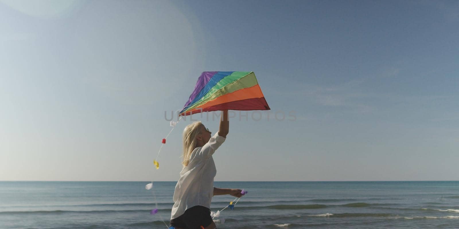 Beautiful Young Woman Holding A Kite at Beach on autumn day