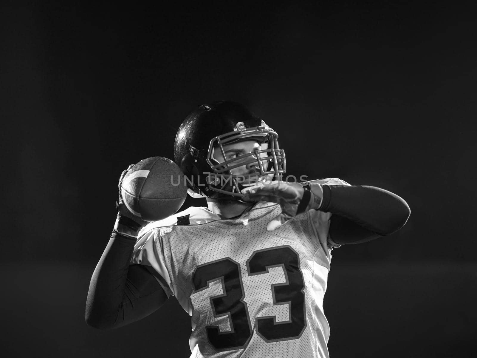 american football player throwing rugby ball by dotshock