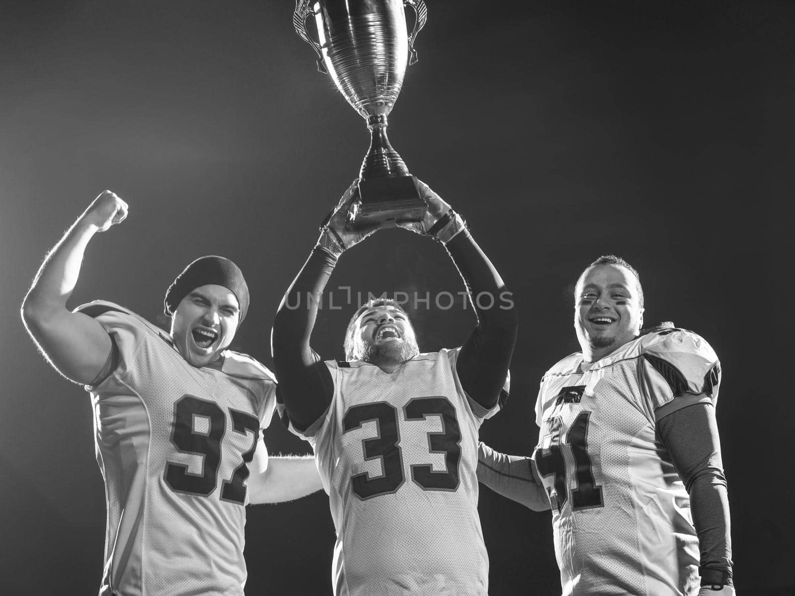 american football team with trophy celebrating victory by dotshock