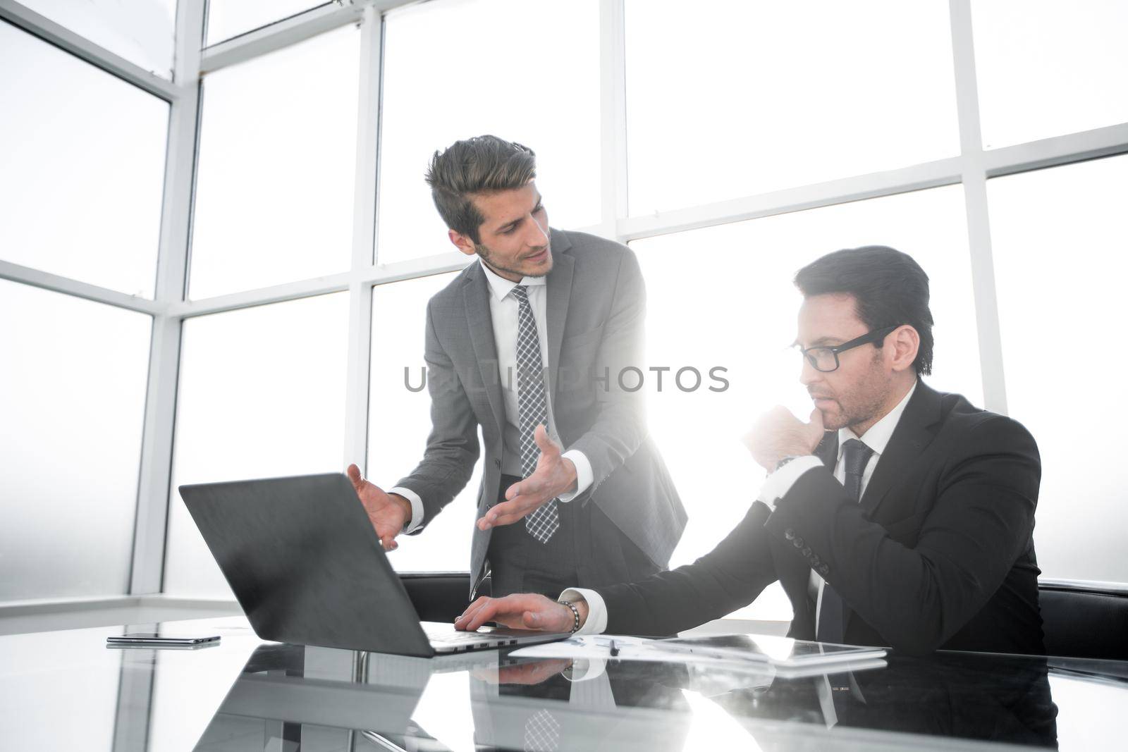 Manager and employee discussing financial documents. business concept