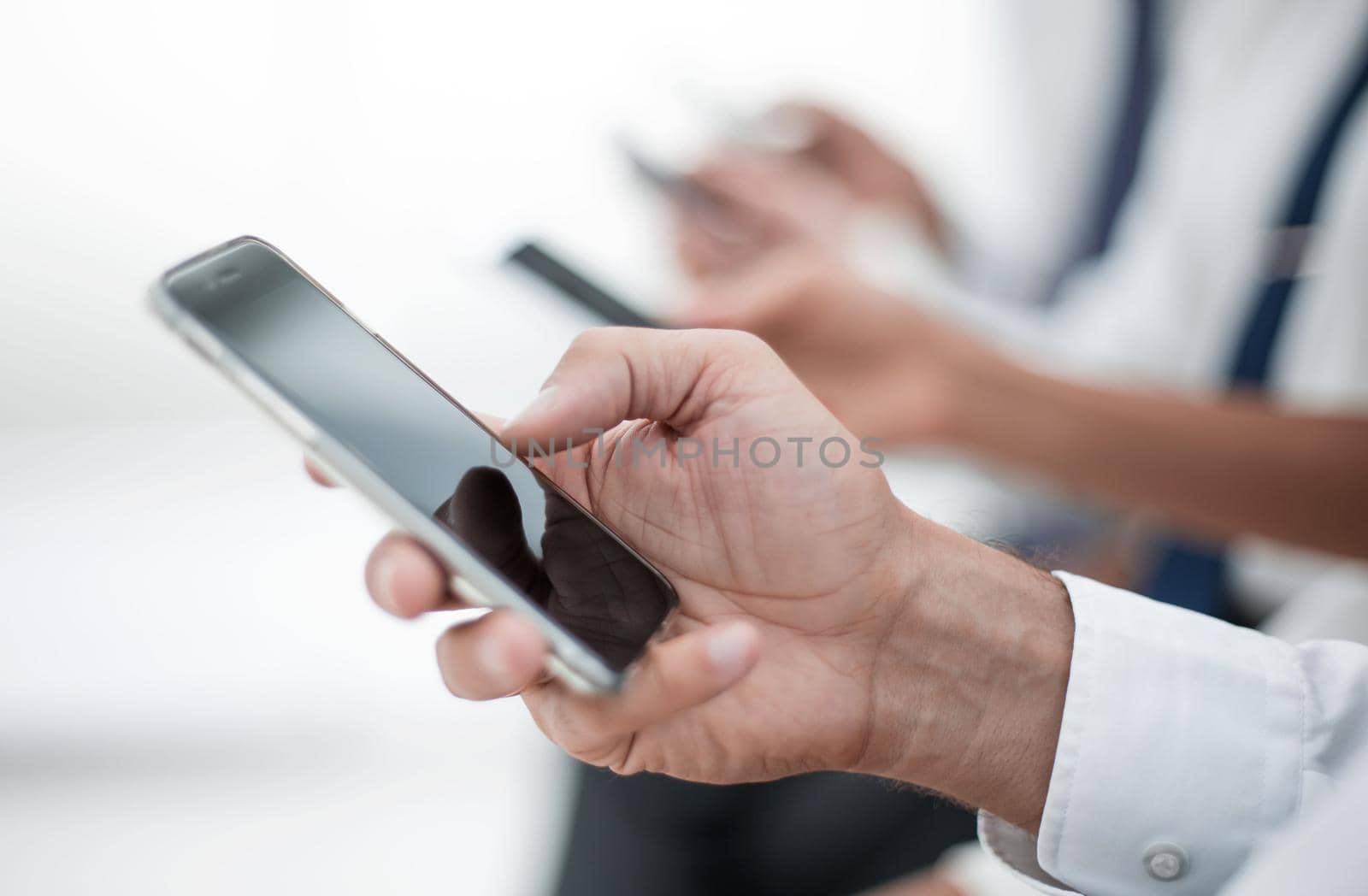 close up.modern smartphone in the hand of a businessman.photo with copy space