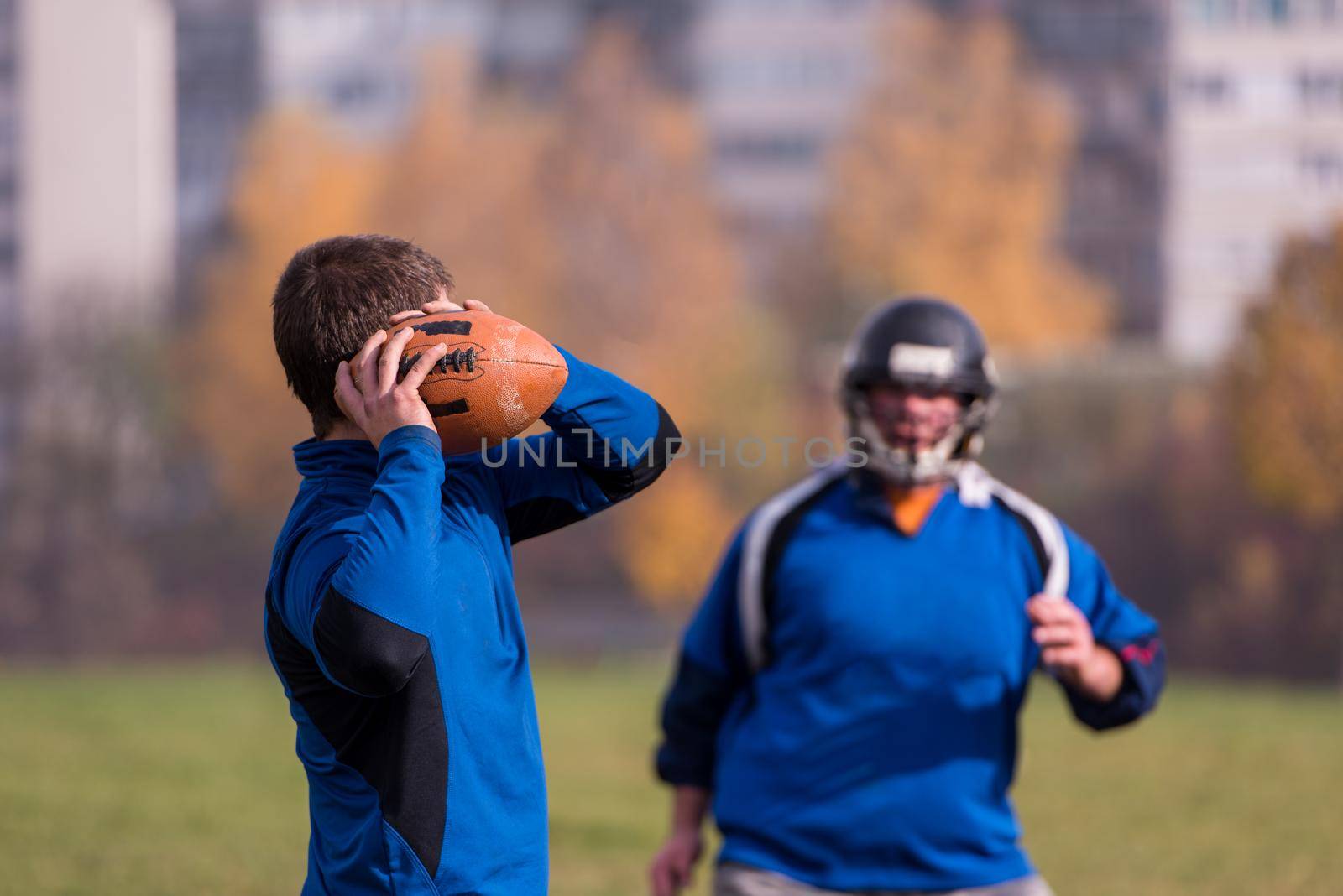american football team with coach in action by dotshock