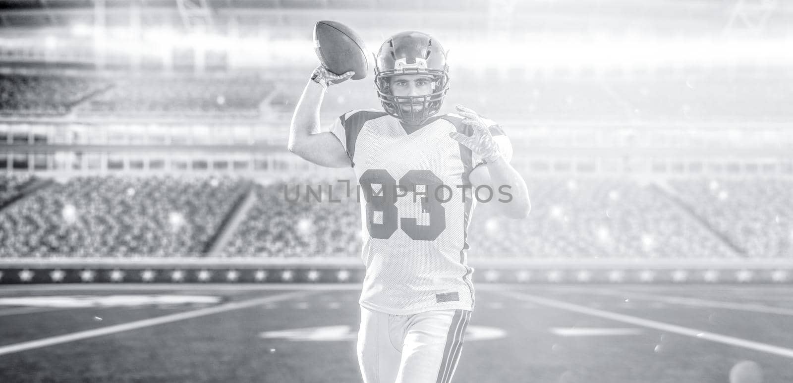 one quarterback american football player throwing ball isolated on big modern stadium field with lights and flares