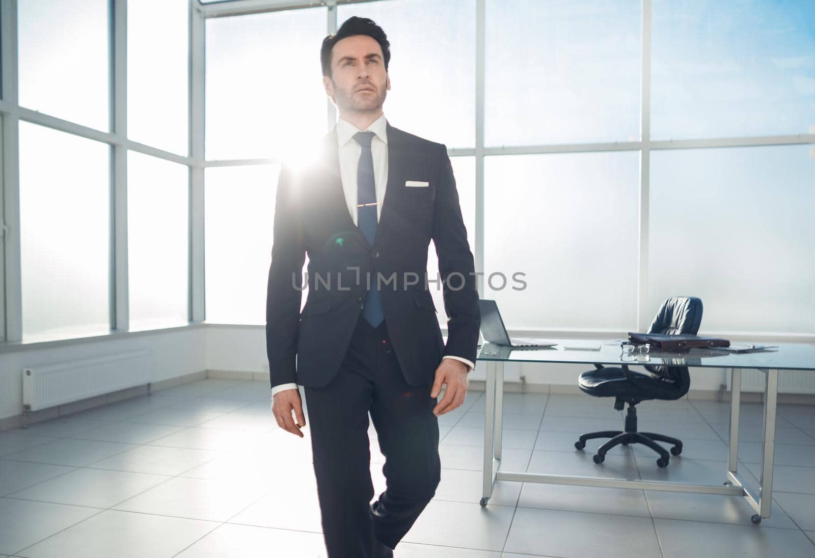 modern businessman standing in a bright office.photo with copy space