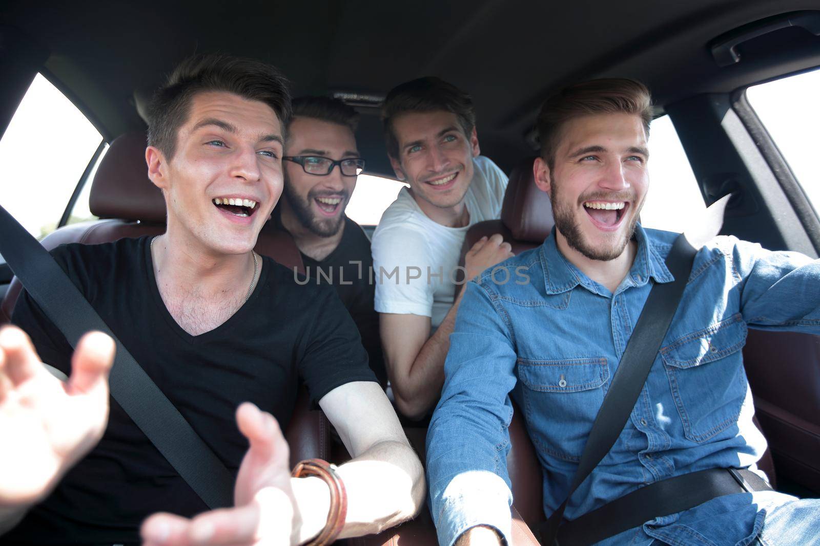 close up. three friends travel in a car by asdf